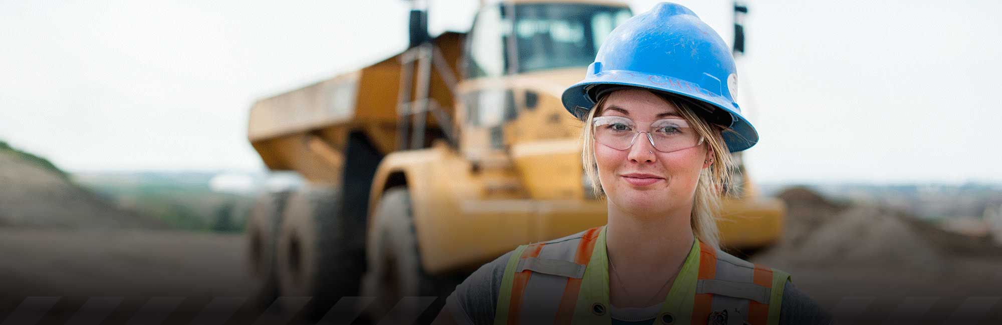 a woman with brown hair wearing a green safety vest