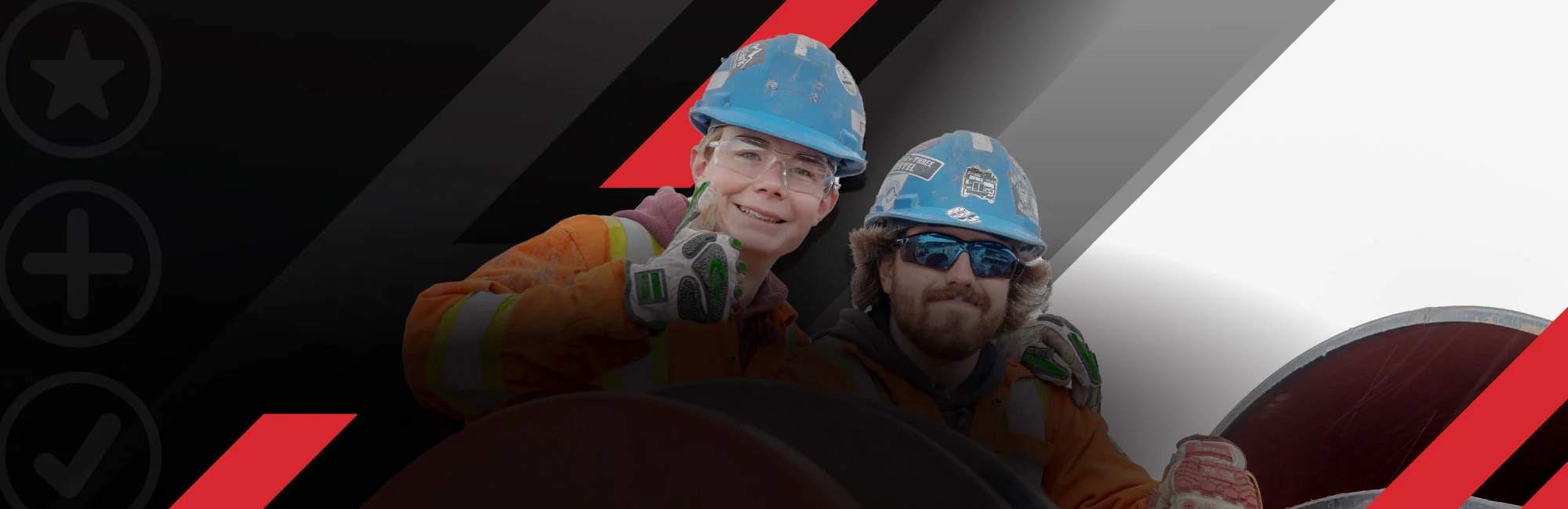 two workers on a pipe in front of mountain