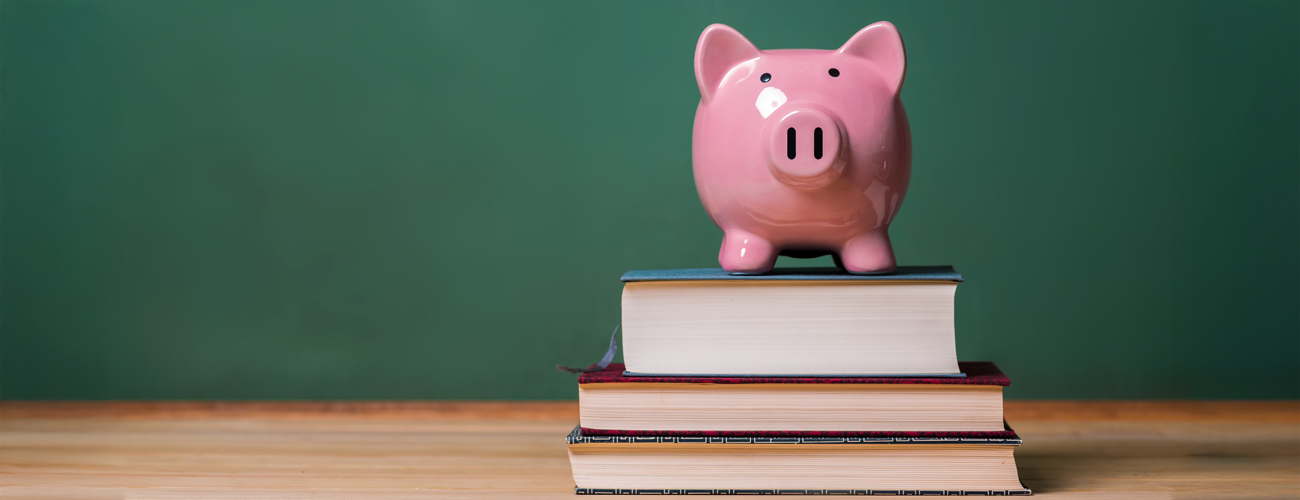 piggy bank sitting on books