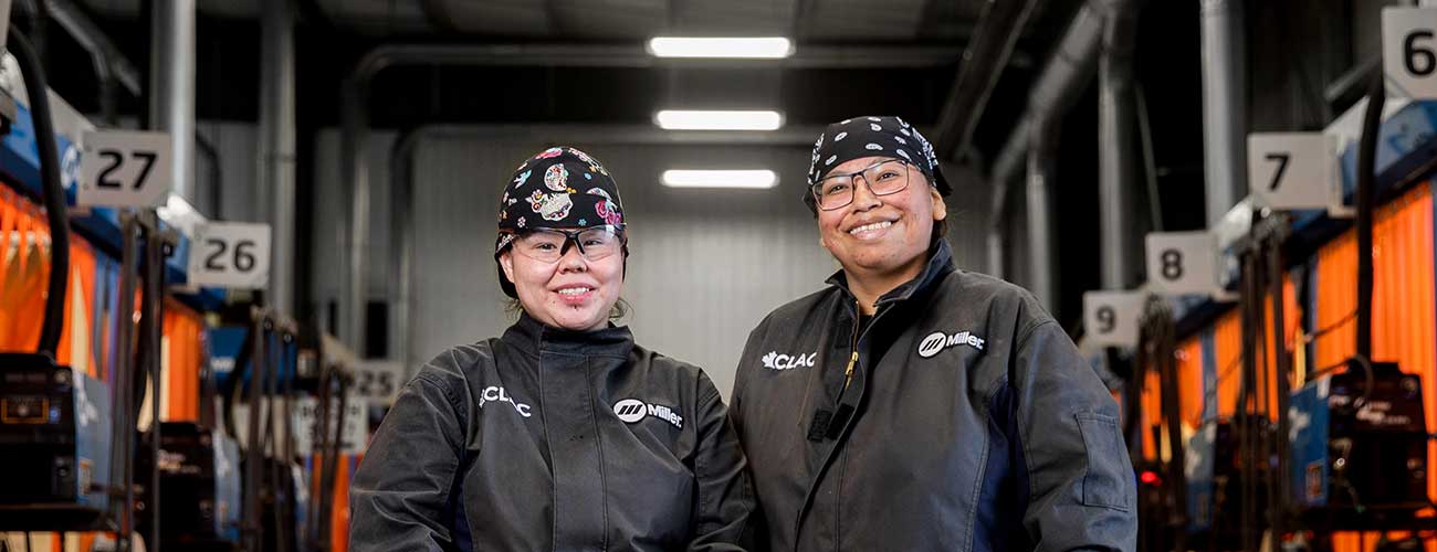 two women in a welding shop