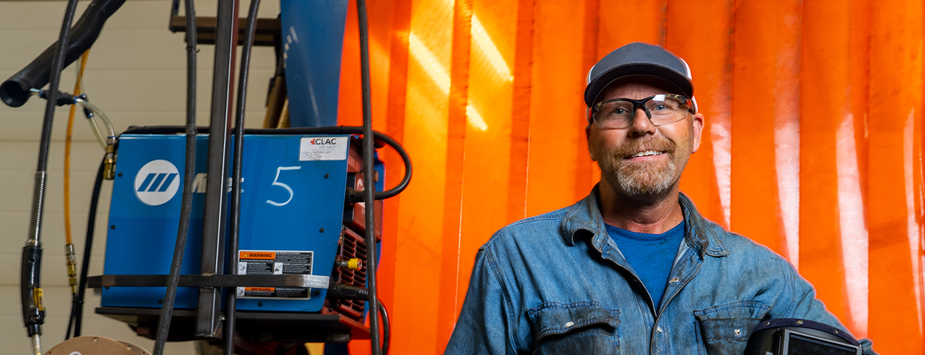 man in a welding booth