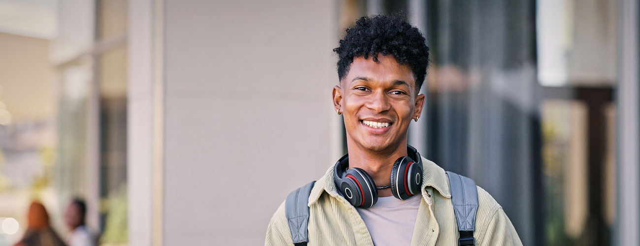 A young man who is a student smiling