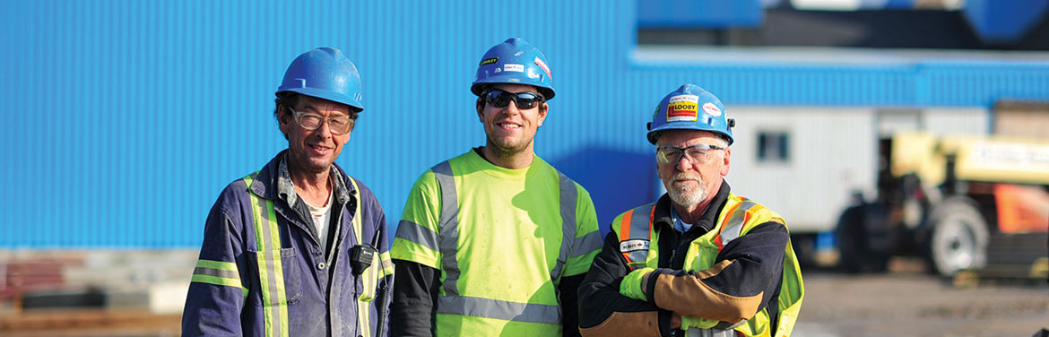 Three construction workers posing for a picture